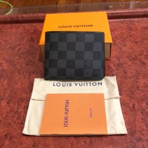 Louis Vuitton men’s gray multiple Damier wallet.